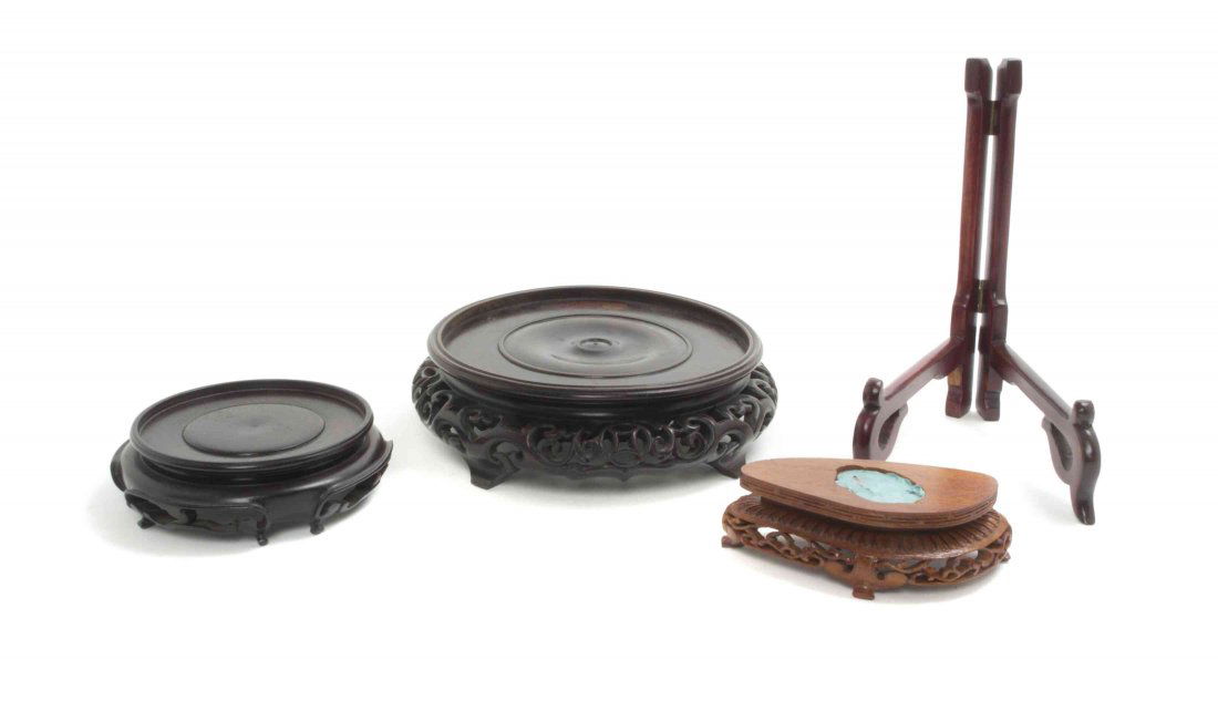 A Collection of Chinese Wood Stands, Diameter of: A Collection of Chinese Wood Stands, comprising two examples of circular form having pierce carved and relief carved aprons, with two others. Diameter of largest 7 1/2 inches.