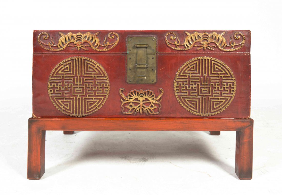 A Chinese Pigskin Case on Stand, Height 12 1/4 x width: A Chinese Pigskin Case on Stand, of rectangular form, having gilt painted accents decorated with bats, shou medallions and a moth, raised on a painted stand with brass hardware. Height 12 1/4 x width 