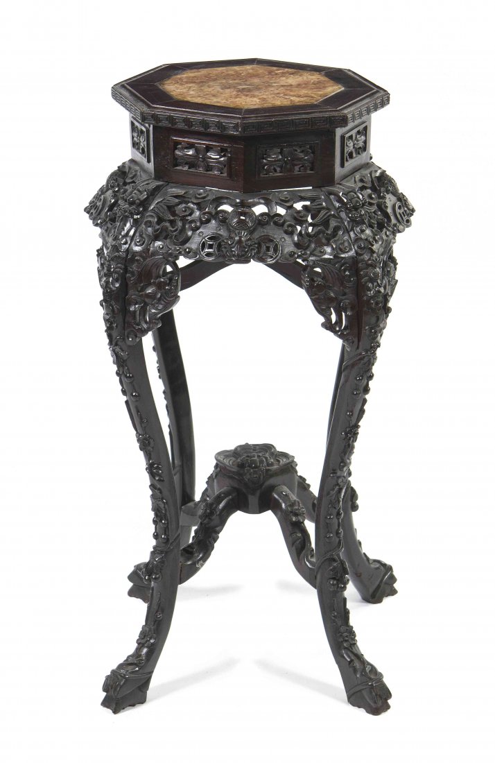A Chinese Hardwood Pedestal, Height 35 inches.: A Chinese Hardwood Pedestal, the octagonal marble inset top over a pierced frieze with foliate decoration, raised on cabriole legs joined by stretchers, ending in hoof feet. Height 35 inches.