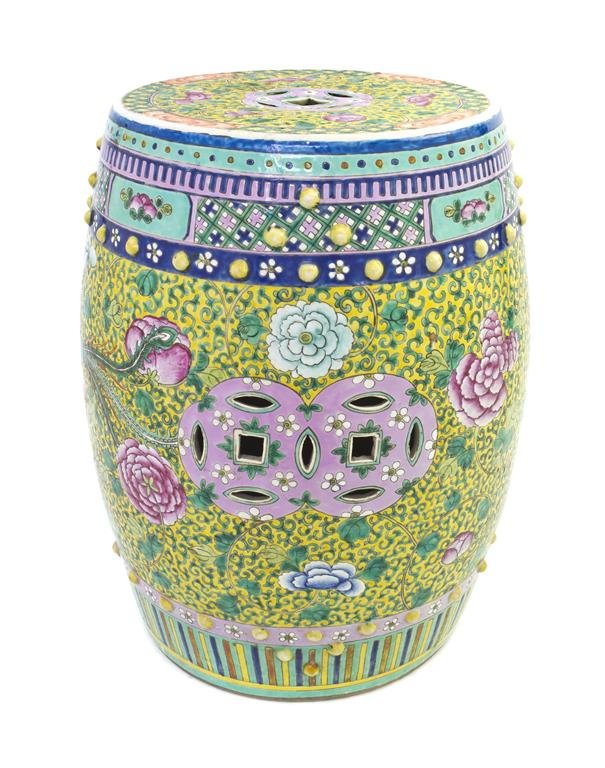 A Chinese Famille Rose Decorated Garden Stool, Height: A Chinese Famille Rose Decorated Garden Stool, of typical drum form with decoration of peony and phoenix set atop a yellow reserve with scrolling vines and flowers. Height 19 inches.
