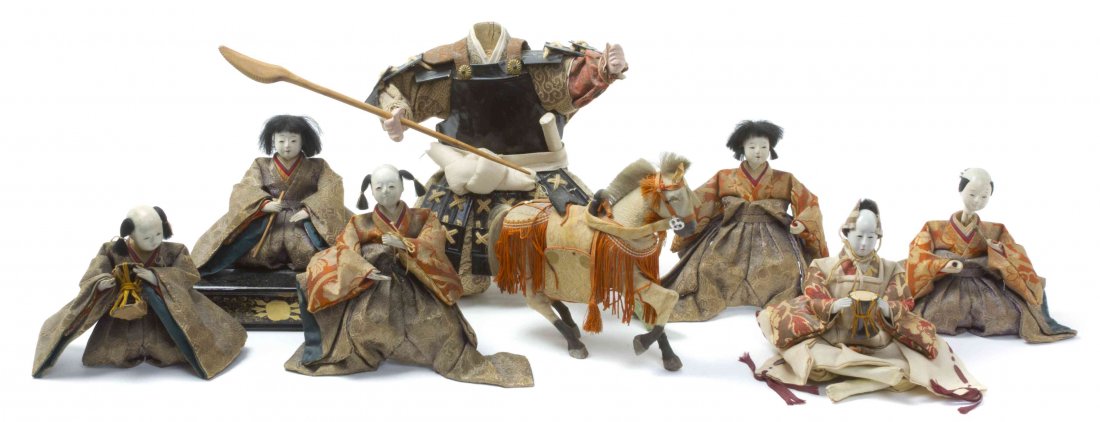 A Group of Eight Japanese Dolls, Height of tallest 9: A Group of Eight Japanese Dolls, comprising six seated men, one standing samurai, and a horse. Height of tallest 9 1/2 inches.