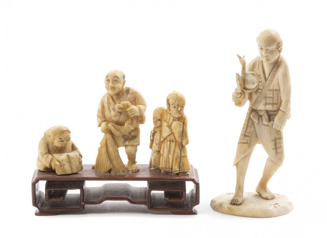 A Japanese Carved Ivory Okimono of a Man, Height of: A Japanese Carved Ivory Okimono of a Man, depicted standing and holding a fruiting branch, raised on a naturalistic base, together with a group of Japanese carved ivory netsuke raised on a pierce carv