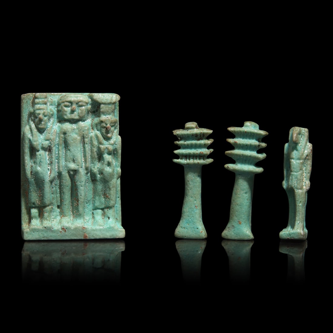 An Egyptian Faience Amulet with the Osirian Triad, two Djed Pillars, and a Thoth Amulet (1 of 2)