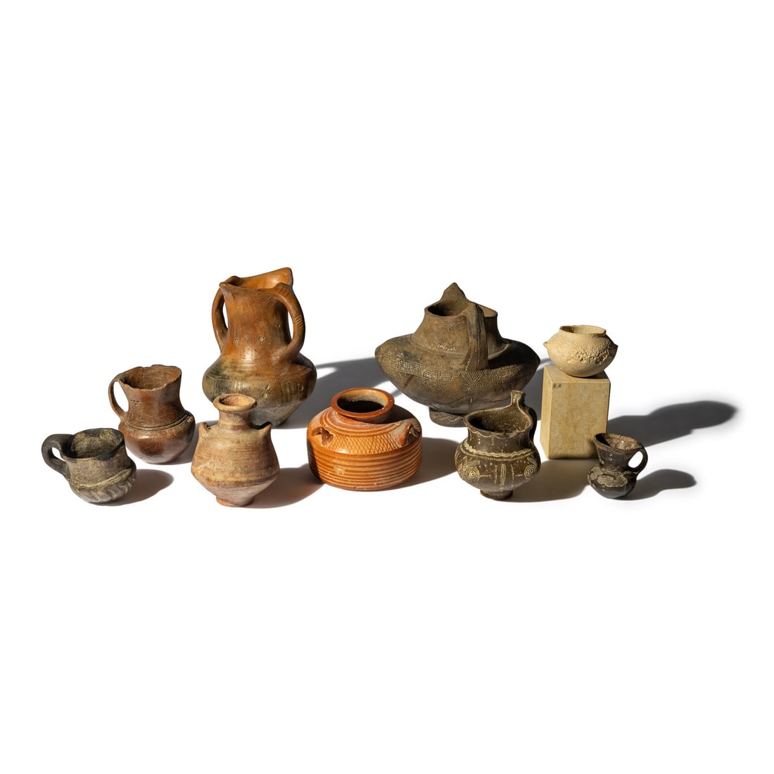 Nine Near Eastern, European Bronze Age, and Greek Terracotta and Stone Vessels: Nine Near Eastern, European Bronze Age, and Greek Terracotta and Stone Vessels Circa 1500-700 B.C. Height of largest 17.6 cm (7 inches). This lot is located in Chicago. Provenance: Art Market, New Yor