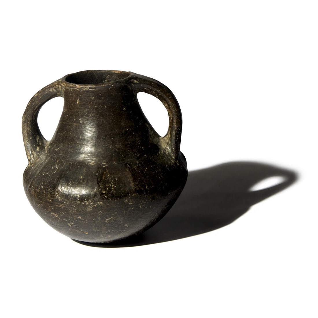 An Etruscan Blackware Amphora: An Etruscan Blackware Amphora Circa 8th Century B.C. Height 16.2 cm (6 3/8 inches). This lot is located in Chicago. Provenance: Howard Nowes, New York; where acquired by the present owner, 10 May 2001