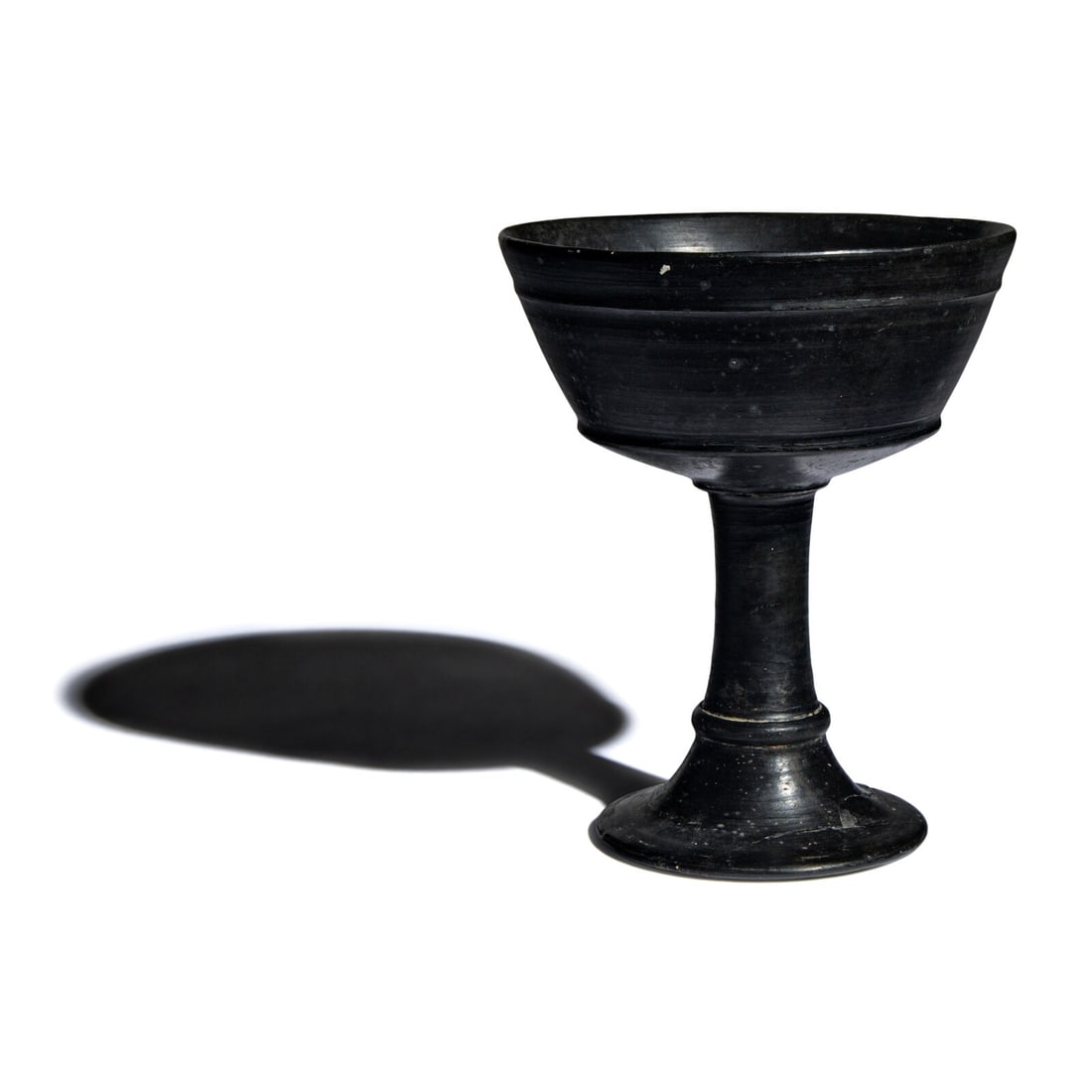 An Etruscan Bucchero Chalice: An Etruscan Bucchero Chalice Circa 4th Century B.C. Height 15.2 cm (6 inches). This lot is located in Chicago. Provenance: Ira & Larry Goldberg Auction, Los Angeles, December Collectibles Auction,