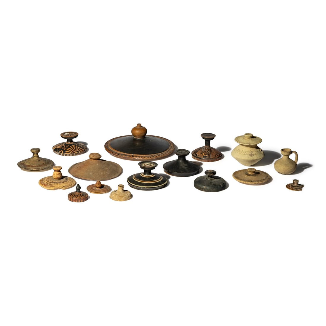 Fifteen Greco-Roman Terracotta Lids and Two Vessels: Fifteen Greco-Roman Terracotta Lids and Two Vessels Circa 6th Century B.C.-2nd Century A.D. Diameter of largest 19.5 cm (7 3/4 inches). Property from a California Private Collection This lot is locate
