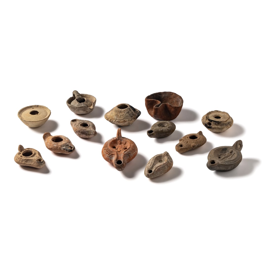 Thirteen Roman and Holy Land Terracotta Lamps: Thirteen Roman and Holy Land Terracotta Lamps Circa Early 1st Millennium B.C.-6th Century A.D. Length of largest 12.3 cm (4 7/8 inches). Property from a California Private Collection This lot is locat