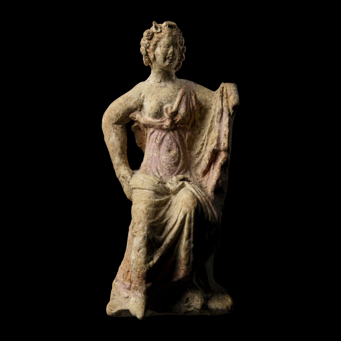 A Greek Terracotta Figure: A Greek Terracotta Figure Circa 4th-3rd Century B.C. Height 14 cm (5 1/2 inches). This lot is located in Chicago. Provenance: Astarte Gallery, London. Gloria and Melville B. Nimmer, Westwood, Californ