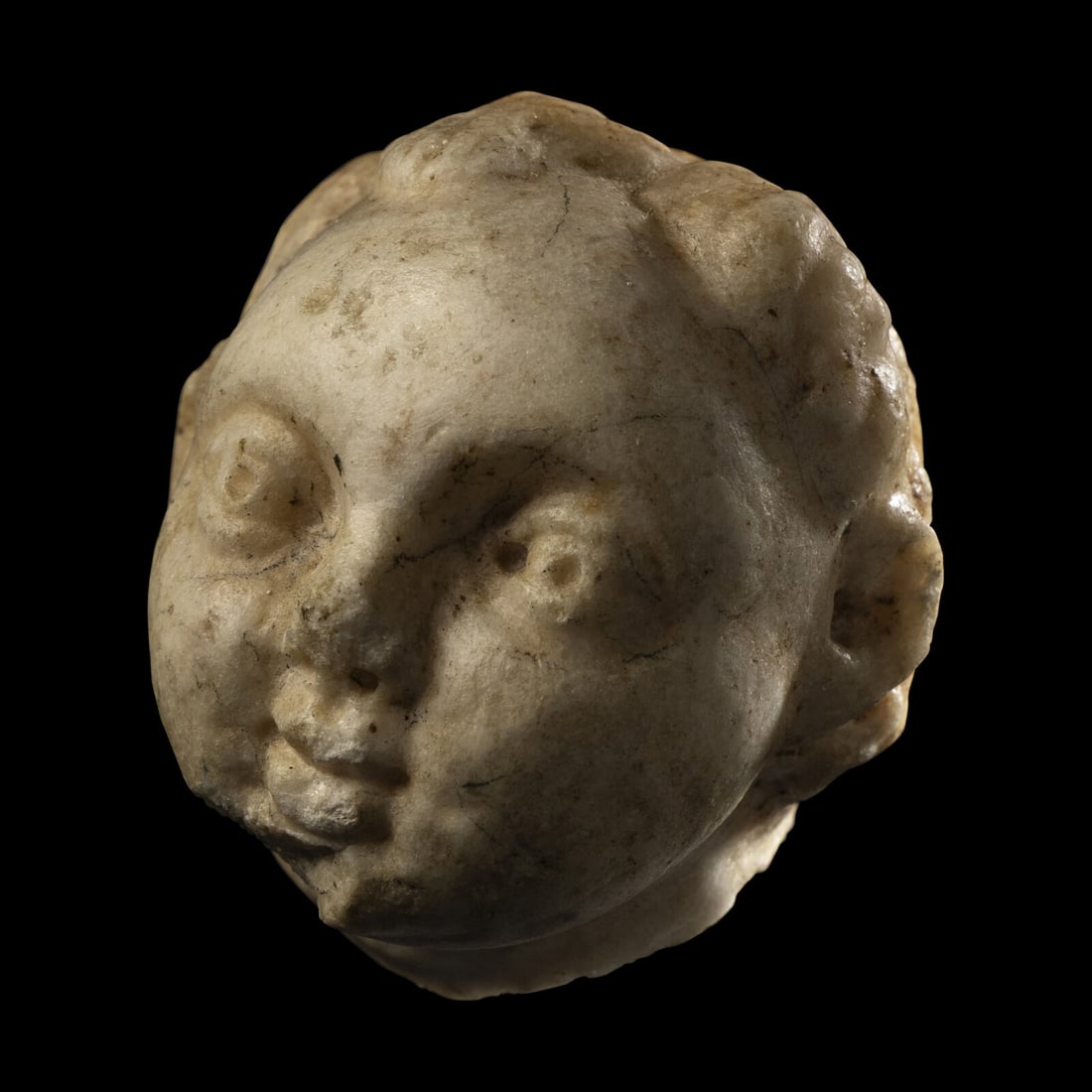 A Roman Marble Head of an Infant: A Roman Marble Head of an Infant Circa 1st-2nd Century A.D. Length 5.6 cm (2 1/4 inches). This lot is located in Chicago. Provenance: Geraldine A. Nager Family Collection, acquired prior to 1998.