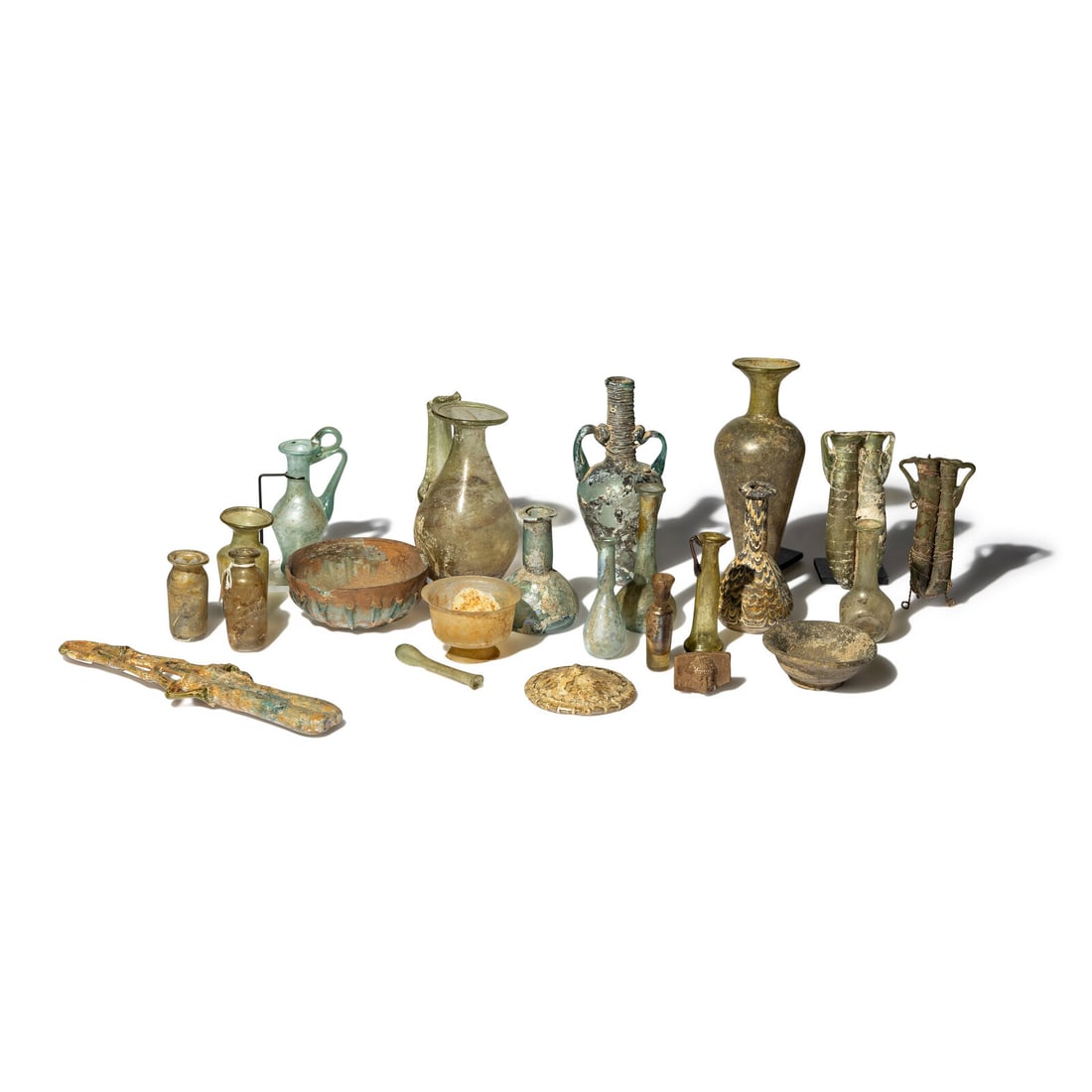 23 Roman Glass Vessels and Fragments: 23 Roman Glass Vessels and Fragments Circa 1st-5th Century and Later Height of largest 26.7 cm (10 1/2 inches). Property from a California Private Collection This lot is located in Chicago. Provenance