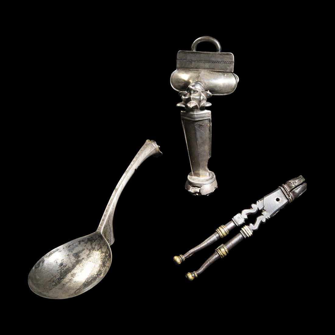Three Continental Silver and Silvered Metal Articles: Three Continental Silver and Silvered Metal Articles Circa 16th-17th Century A.D. or Later comprising a silver fibula, christening spoon and pair of pliers. Length of spoon 15 cm (5 7/8 inches). This 