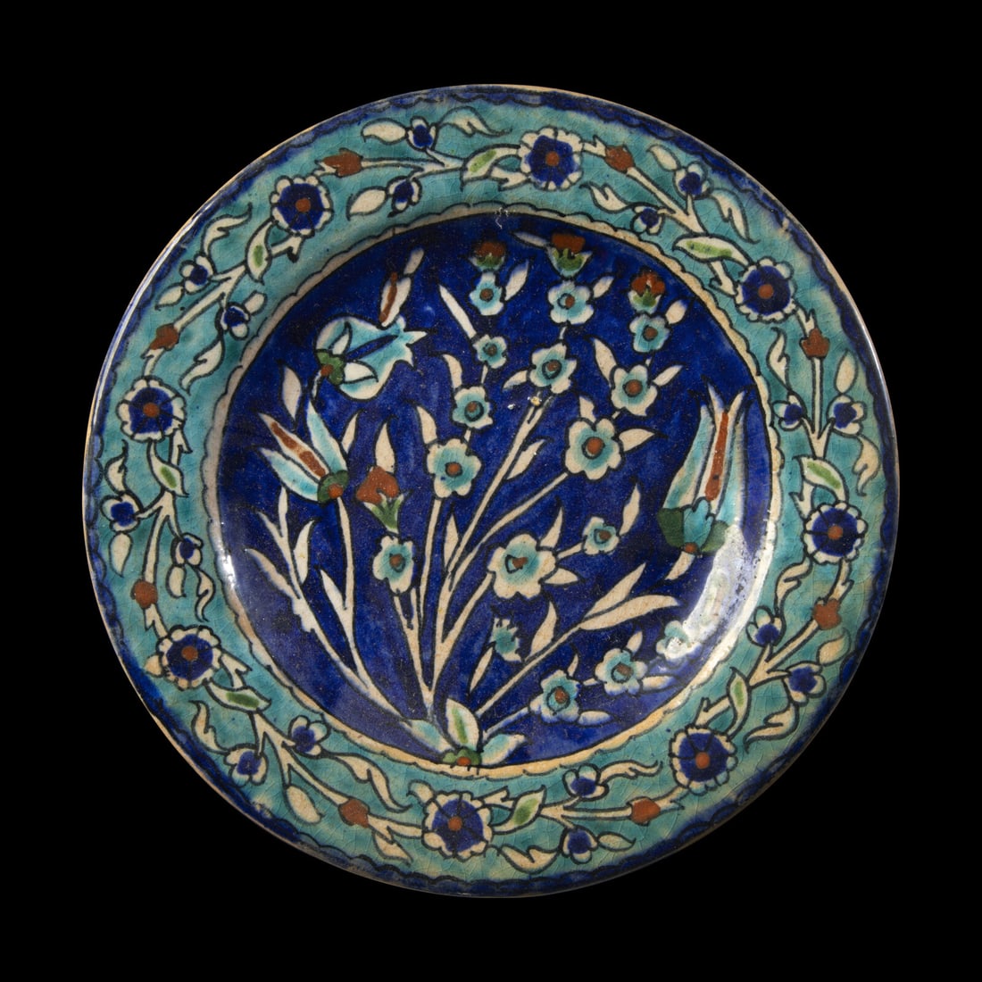 An Iznik Glazed Ceramic Dish: An Iznik Glazed Ceramic Dish Circa 16th-17th Century A.D. or Later Diameter 21.3 cm (8 3/8 inches). This lot is located in Chicago. Provenance: David B. Lawall (d. 2025) Collection, former Director an