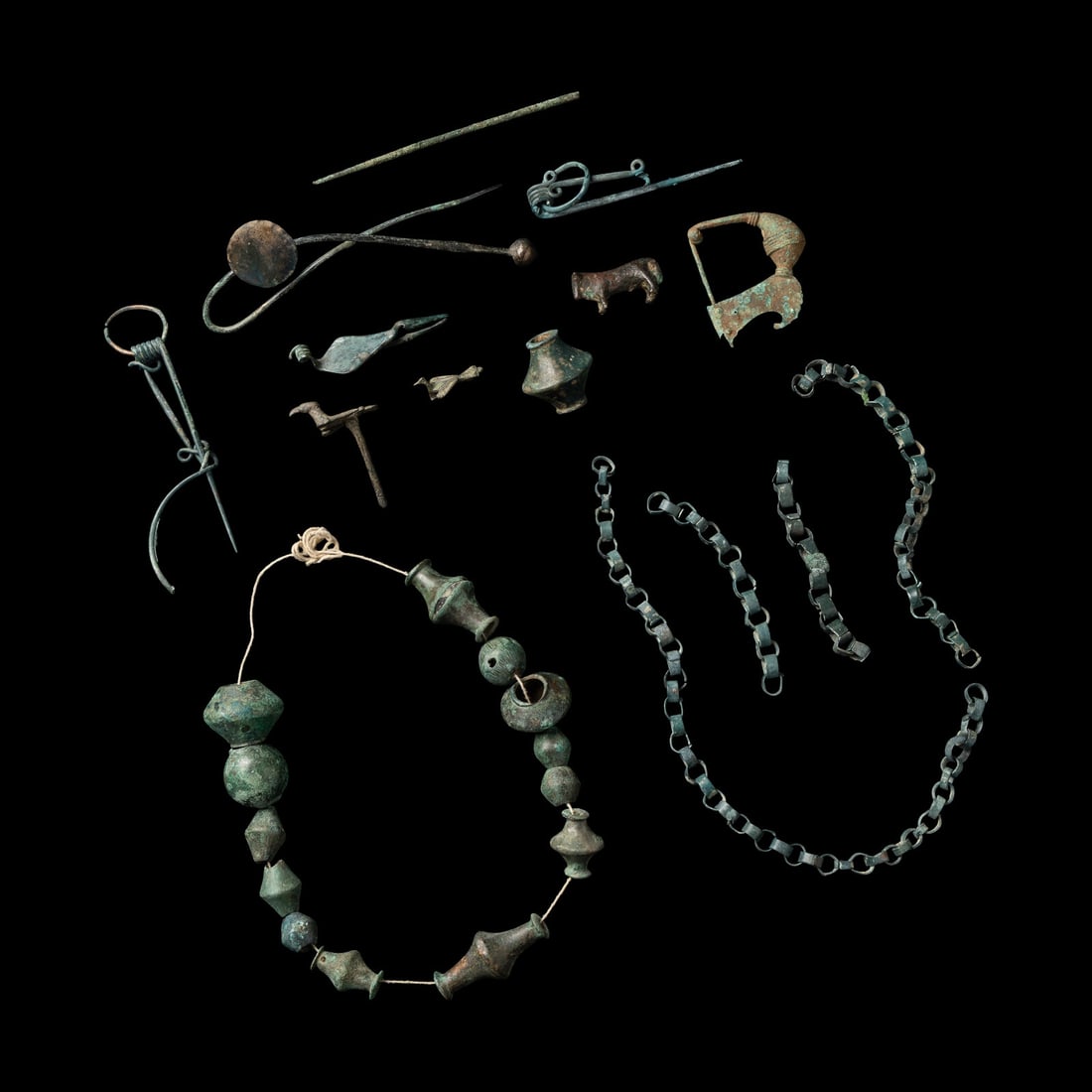 A Group of European and Luristan Bronze Fragmentary Fibulae, Beads, and Chains (1 of 2)