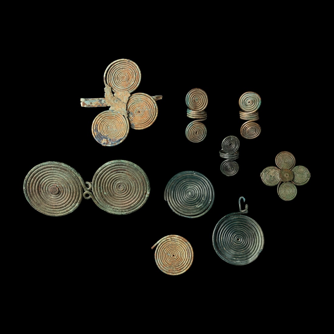 Nine European Bronze Age Spectacle Rings and Fibulae Fragments: Nine European Bronze Age Spectacle Rings and Fibulae Fragments Circa 1200-800 B.C. Length of largest 15 cm (5 7/8 inches). This lot is located in Chicago. Provenance: Art Market, New York, 1980s-2000s