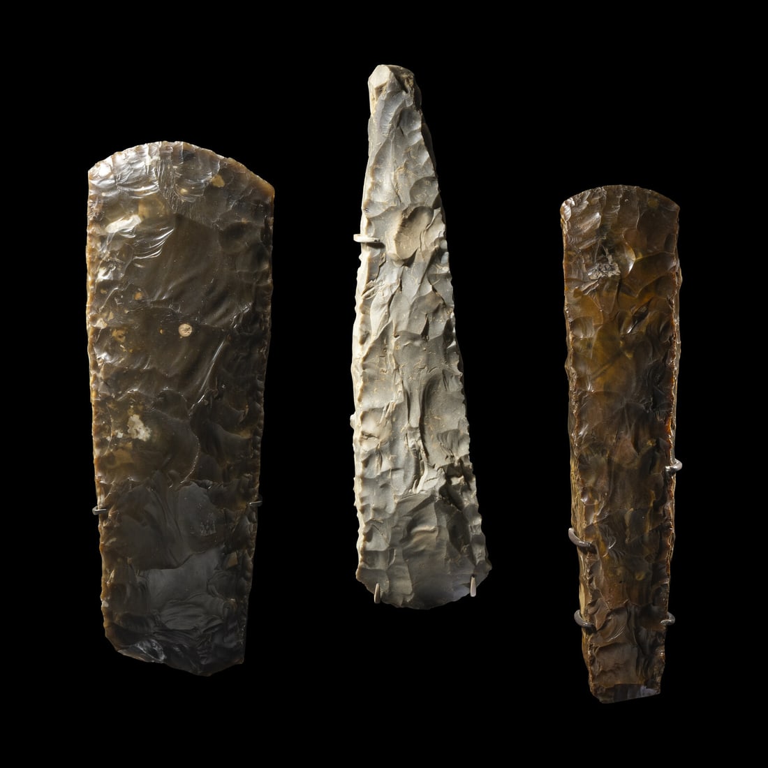 Three Neolithic Flint Axes: Three Neolithic Flint Axes Scandinavia, Circa 4th-3rd Millennium B.C. Length of largest 29 cm (11 3/8 inches). This lot is located in Chicago. Provenance: K. John Hewitt (1919-1994), Kent, United