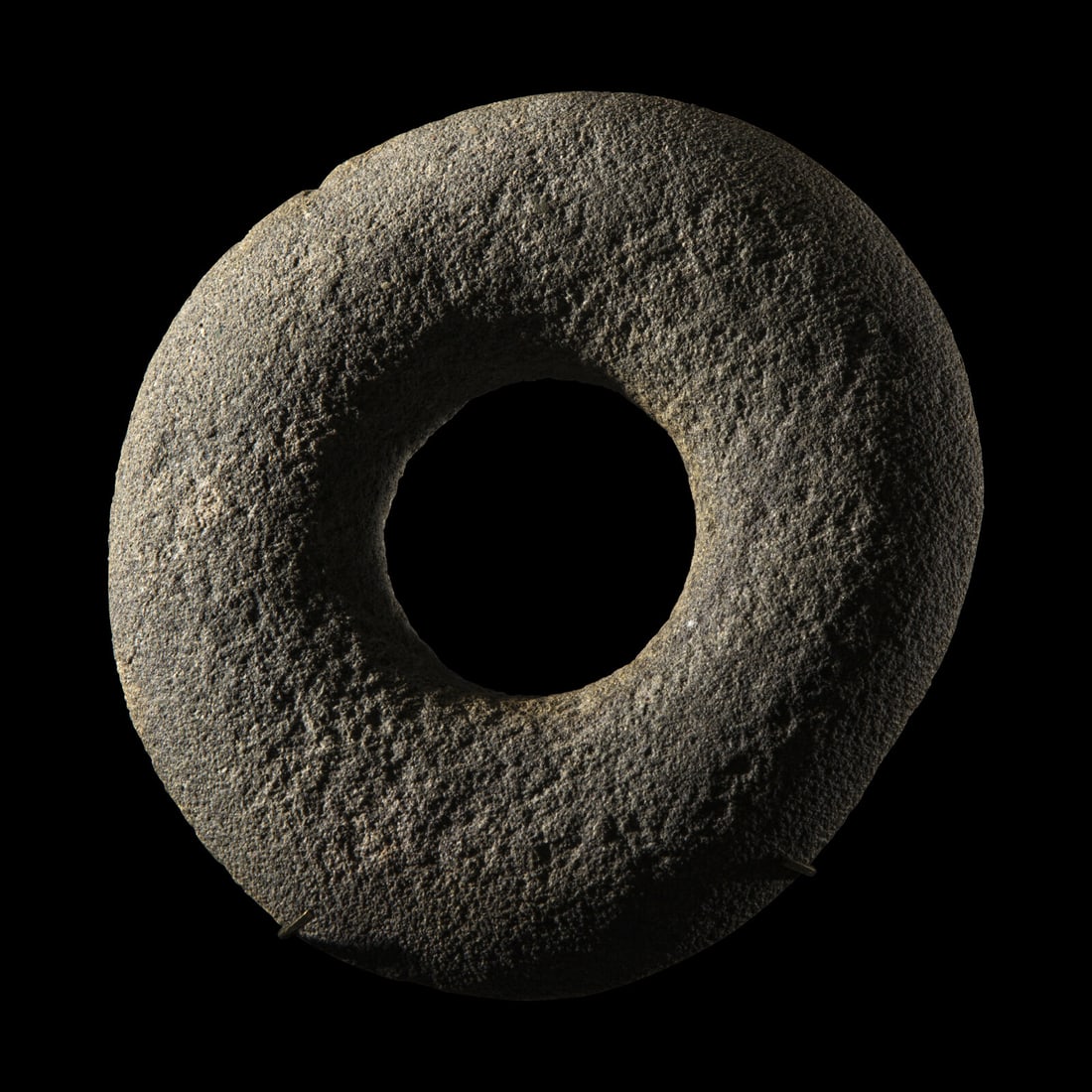 A Neolithic Greystone Ring: A Neolithic Greystone Ring Central Africa, Circa 3000-2000 B.C. Width 14.5 cm (5 3/4 inches). This lot is located in Chicago. Provenance: Ed Francis Collection, primarily formed in the 1950s.