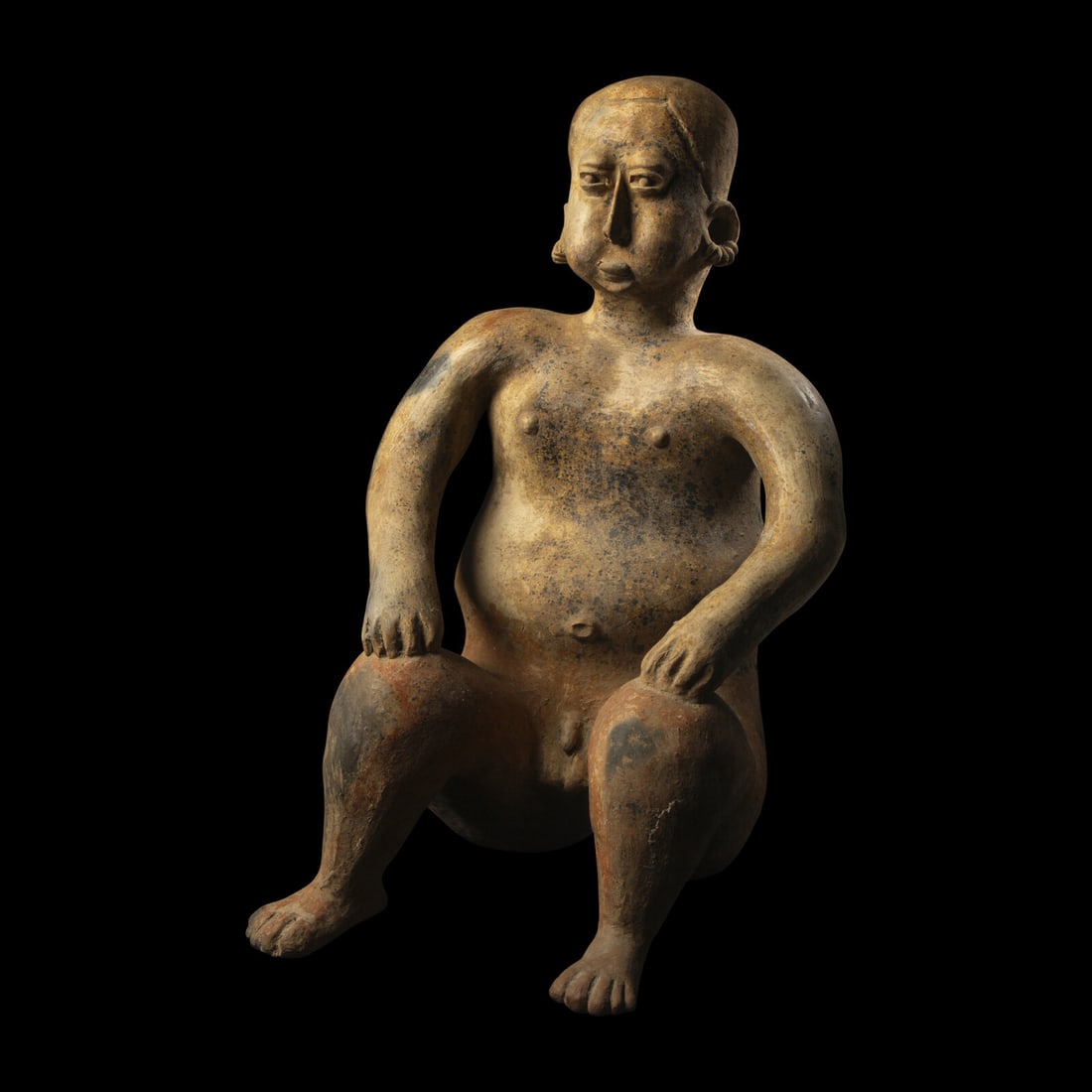 A Jalisco Terracotta Seated Male Figure: A Jalisco Terracotta Seated Male Figure West Mexico, Circa 1st Century B.C.-2nd Century A.D. Height 53.5 cm (21 1/8 inches). This lot is located in Chicago. Provenance: The Lands Beyond, New York.