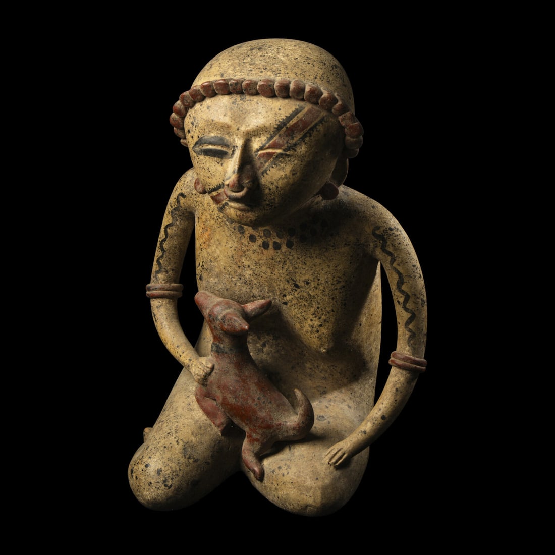 A Nayarit Terracotta Seated Figure with Dog: A Nayarit Terracotta Seated Figure with Dog West Mexico, Circa 1st Century B.C.-2nd Century A.D. Height 31 cm (12 1/4 inches). This lot is located in Chicago. Provenance: The Lands Beyond, New York.