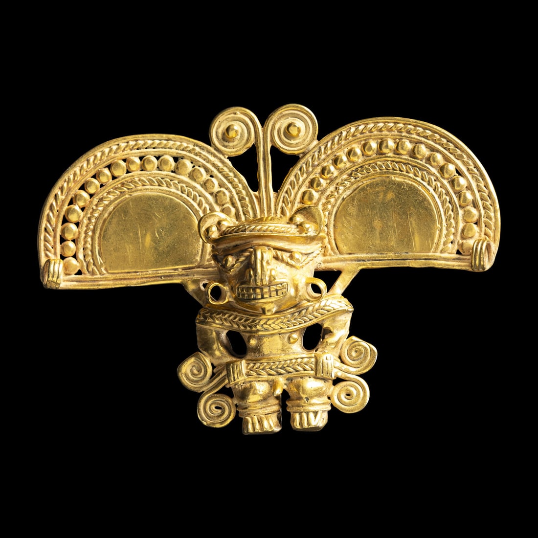 A Tairona Gold Pendant: A Tairona Gold Pendant Colombia, Circa 1000-1500 A.D. Width 8.5 cm (3 3/8 inches). Property from the Collection of Aiden Dorn, St. Paul, Minnesota This lot is located in Chicago. Provenance: Estate of