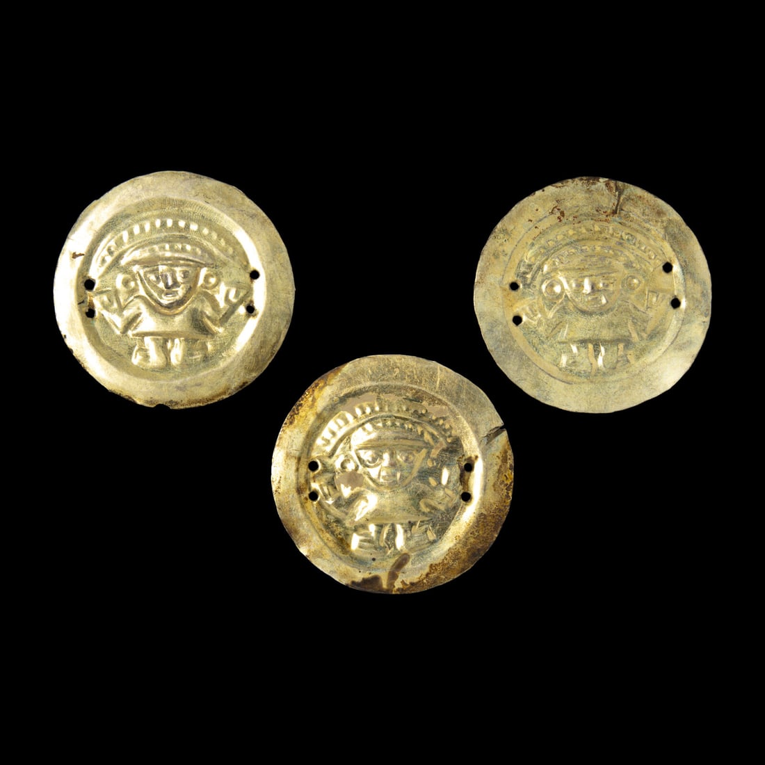Three Chimu Gold Alloy Discs: Three Chimu Gold Alloy Discs Peru, Circa 1100-1400 A.D. Diameter of largest 5.3 cm (2 1/8 inches). This lot is located in Chicago. Provenance: Arts of The Four Quarters, New York. Jan Mitchell (former