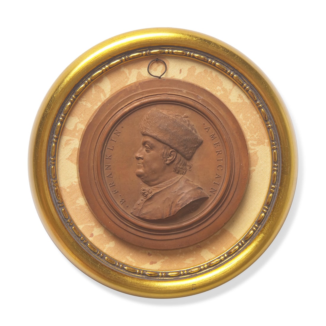Jean-Baptiste Nini (Italian, 1717-1786), A Terracotta Portrait Medallion of Benjamin Franklin with: Jean-Baptiste Nini (Italian, 1717-1786), A Terracotta Portrait Medallion of Benjamin Franklin with Fur Hat Dated, "1777" with legend, B. FRANKLIN AMERICAIN, and below the bust coat of arms of hand hol