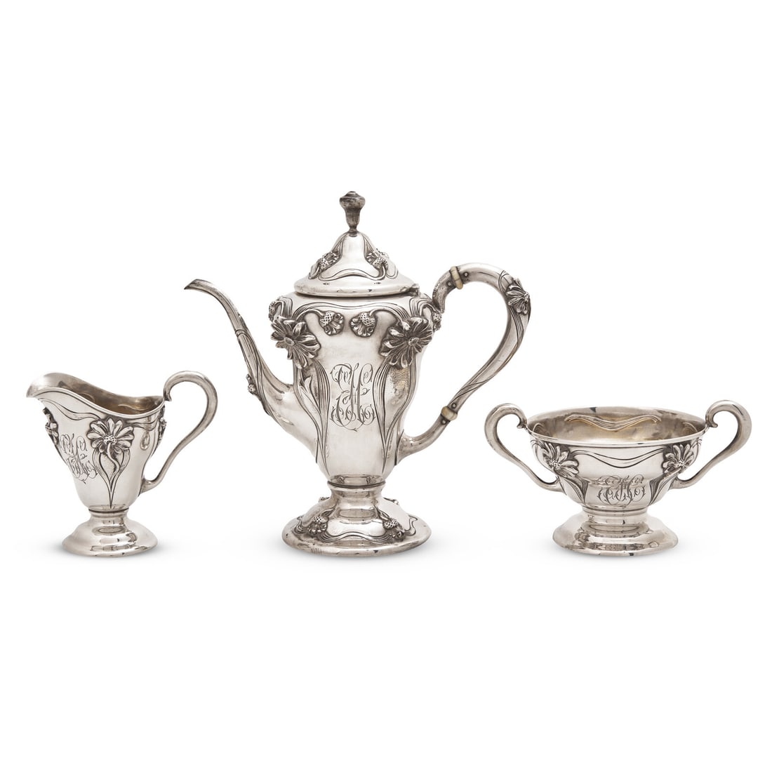 An Art Nouveau Three-Piece Sterling Silver Floral Cast and Repousse Coffee Service: An Art Nouveau Three-Piece Sterling Silver Floral Cast and Repousse Coffee Service William B. Kerr & Co., Newark, New Jersey, Retailed by William Wise & Son, Brooklyn, New York, Circa 1900 comprising 