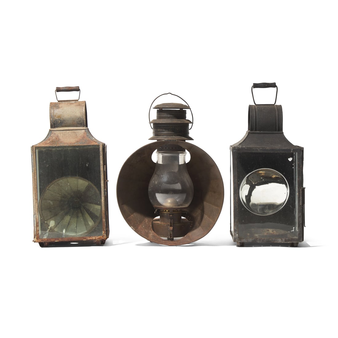 Three Tinware Lanterns: Three Tinware Lanterns 19th Century comprising an oil lantern and two lanterns with mirrored reflectors. Height 25 x width 10 1/2 x depth 10 1/4 inches (tallest). This lot is located in Philadelphia. 