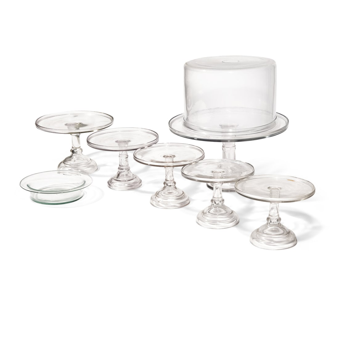 A Group of Six Blown and Cast Glass Cake Stands, Together with a Bowl: A Group of Six Blown and Cast Glass Cake Stands, Together with a Bowl 19th / 20th Century the largest stand with domed cover. Height 16 x diameter 15 1/2 inches (largest, including cover). This lot is