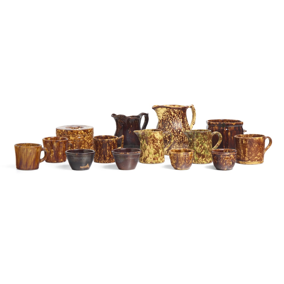 A Group of Fourteen Bennington or Rockingham Glazed Earthenware Items: A Group of Fourteen Bennington or Rockingham Glazed Earthenware Items Circa 1850 including items by United States Pottery Co. (1852-1858), Bennington, Vermont, circa 1849-1858; comprising four pitcher