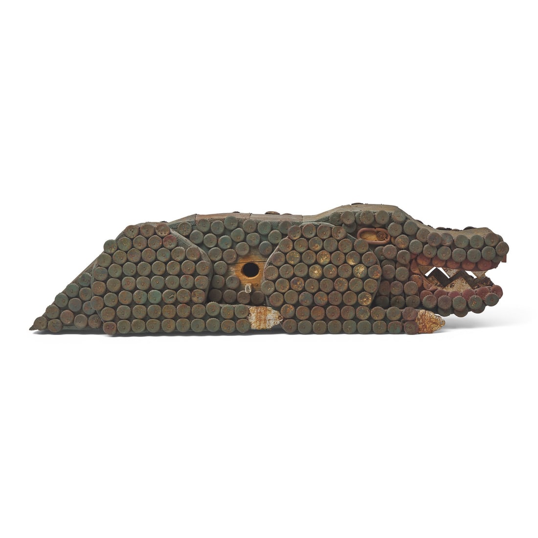 A Found Object Alligator-Form Bird House: A Found Object Alligator-Form Bird House Bivalve, New Jersey, 20th Century comprised of painted wood, pressed tin, and bottle caps. Height 10 x width 38 x depth 8 inches. This lot is located in Philad