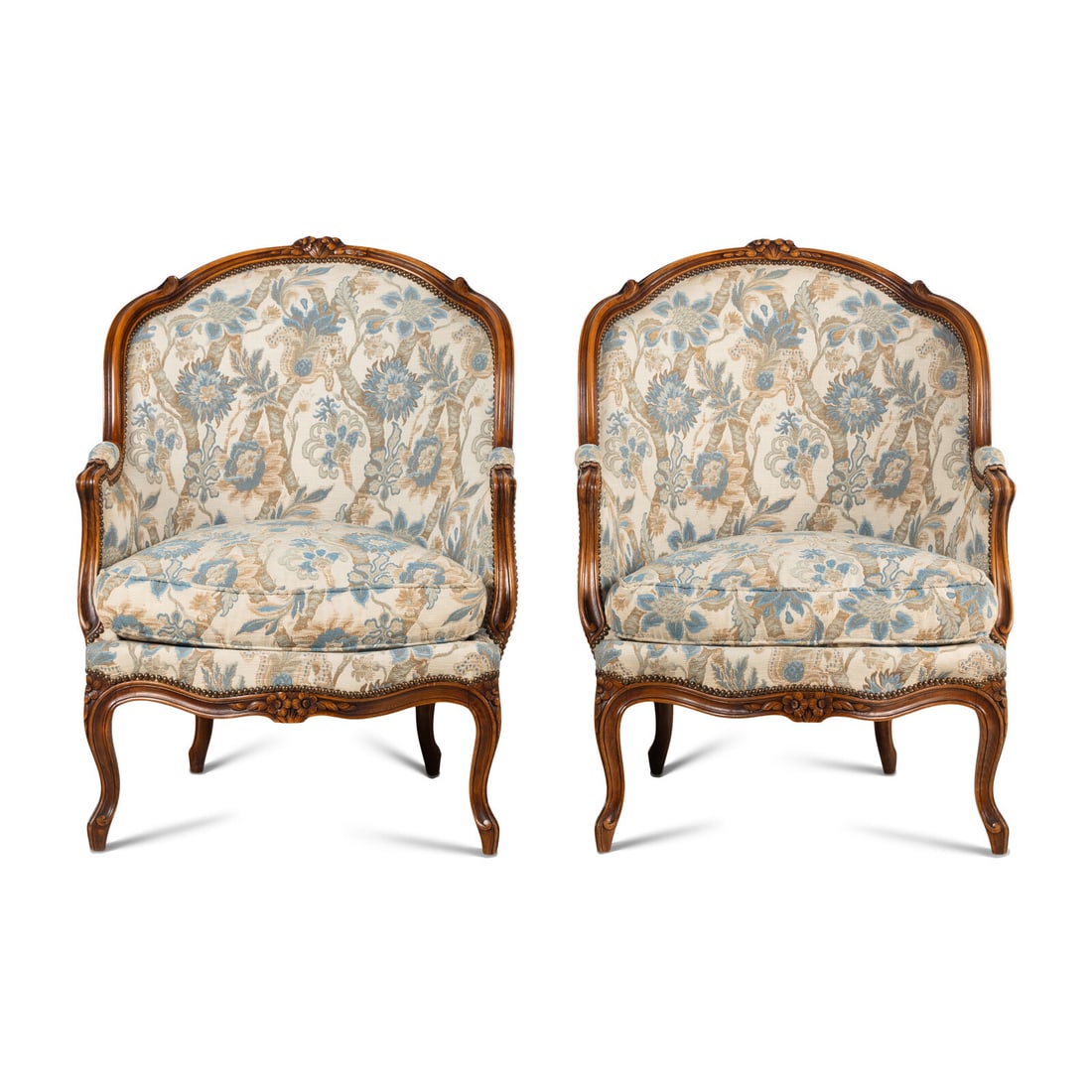 A Pair of Louis XV Style Walnut Bergères: A Pair of Louis XV Style Walnut Bergères 20th Century Height 38 1/2 x width 28 x depth 22 inches. Property from the Collection of Dawn Paquelet This lot is located in Chicago.
