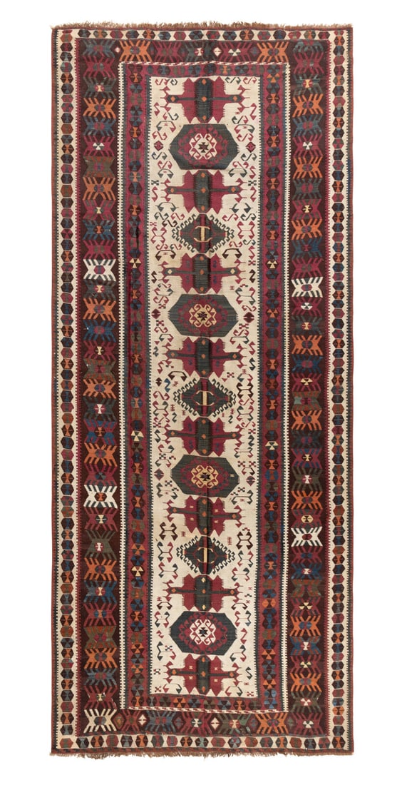 A Kilim Runner: A Kilim Runner 11 feet 4 inches x 5 feet 1 inch. This lot is located in Chicago.