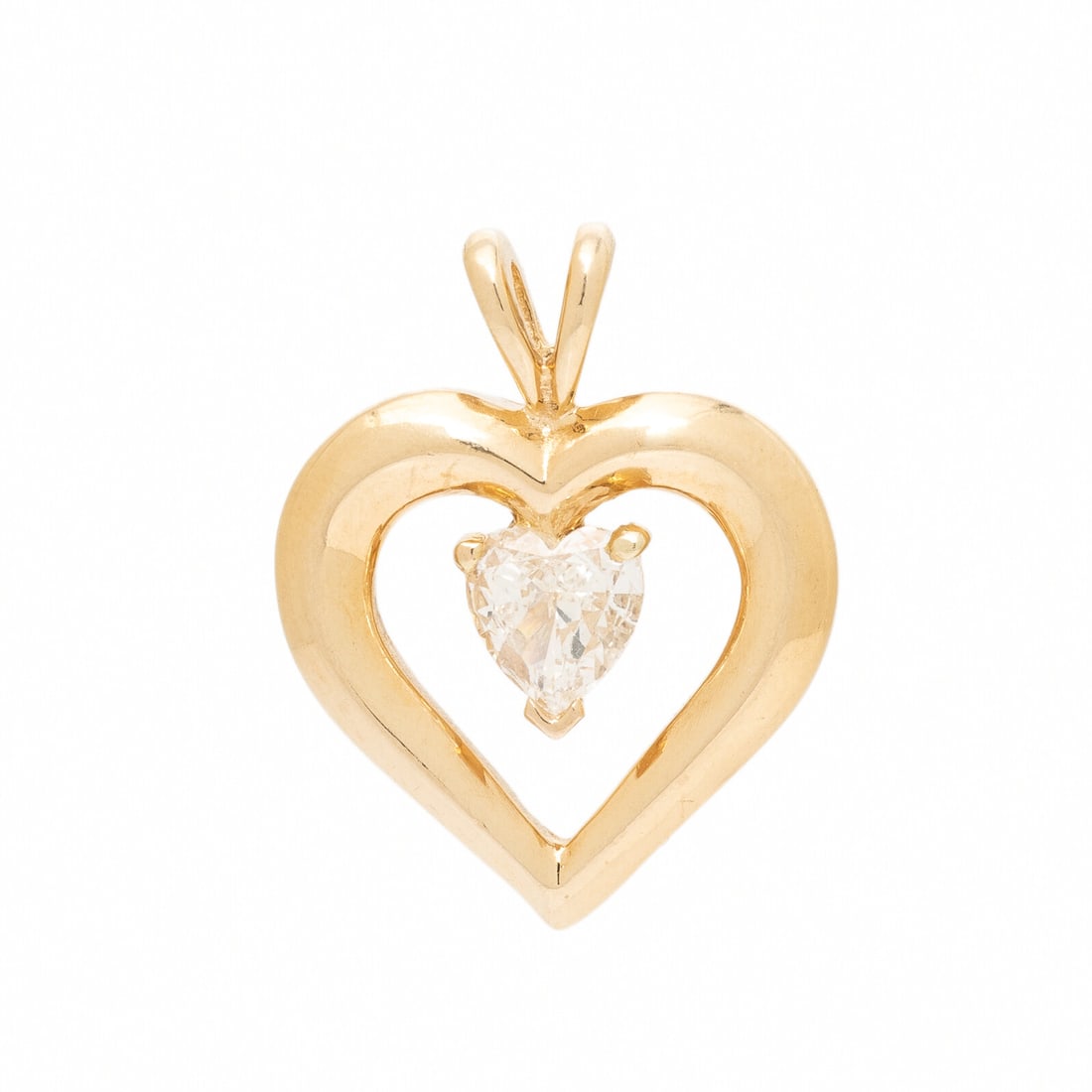 Diamond and Yellow Gold Heart Pendant: Diamond and Yellow Gold Heart Pendant Heart-shape diamond weighing approximately 0.75 carat by formula. Yellow gold. 1 inch long. Gross weight: 3.75 dwt. Property of a Private Collection This lot is