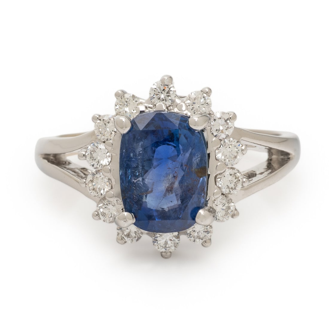 Sapphire, Diamond, and White Gold Ring: Sapphire, Diamond, and White Gold Ring Cushion cut sapphire weighing approximately 2.50 carats by formula and round brilliant cut diamonds. 14 karat white gold. Ring size 6. Stamp: 14K. Gross weight: 