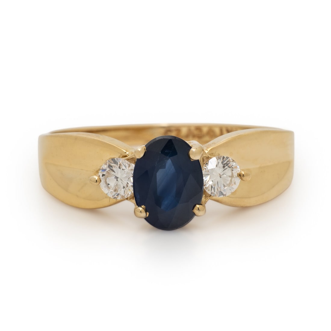 Sapphire, Diamond, and Yellow Gold Ring: Sapphire, Diamond, and Yellow Gold Ring Oval cut sapphire weighing approximately 0.90 carat by formula and round brilliant cut diamonds. 14 karat white gold. Ring size 7 3/4. Stamp: 14KT EV23. Gross