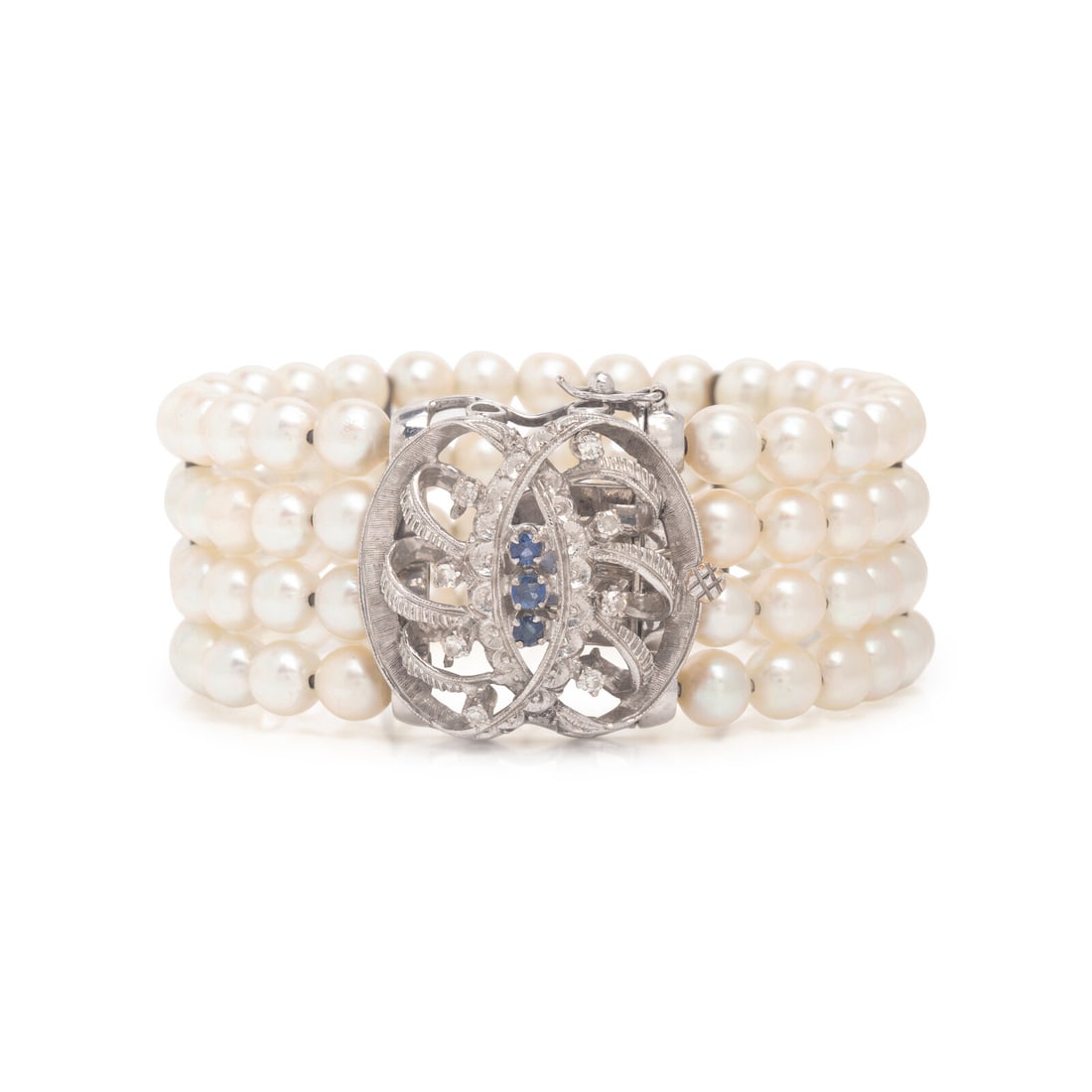 Cultured Pearl, White Gold, and Sapphire Bracelet: Cultured Pearl, White Gold, and Sapphire Bracelet Cultured pearls measuring approximately 5.60 - 5.80 mm, round sapphires, and single cut diamonds. 18 karat white gold. 5 3/4 inches inner circumferenc