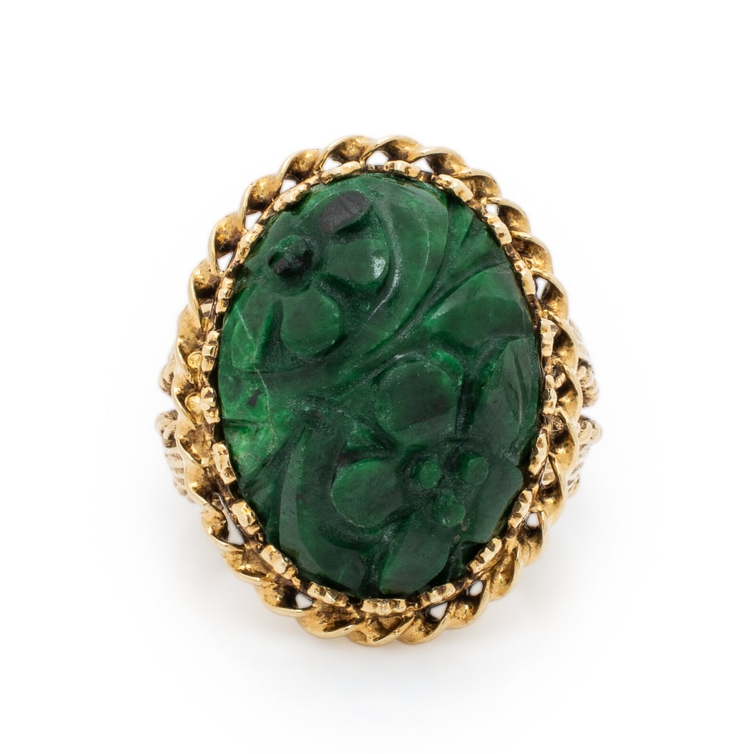 Carved Hardstone and Yellow Gold Ring: Carved Hardstone and Yellow Gold Ring Oval carved green hardstone measuring approximately 19.80 x 15.00 x 7.30 mm. 14 karat yellow gold. Ring size 7. Stamp: (partially obscured) 14K. Gross weight: 6.4
