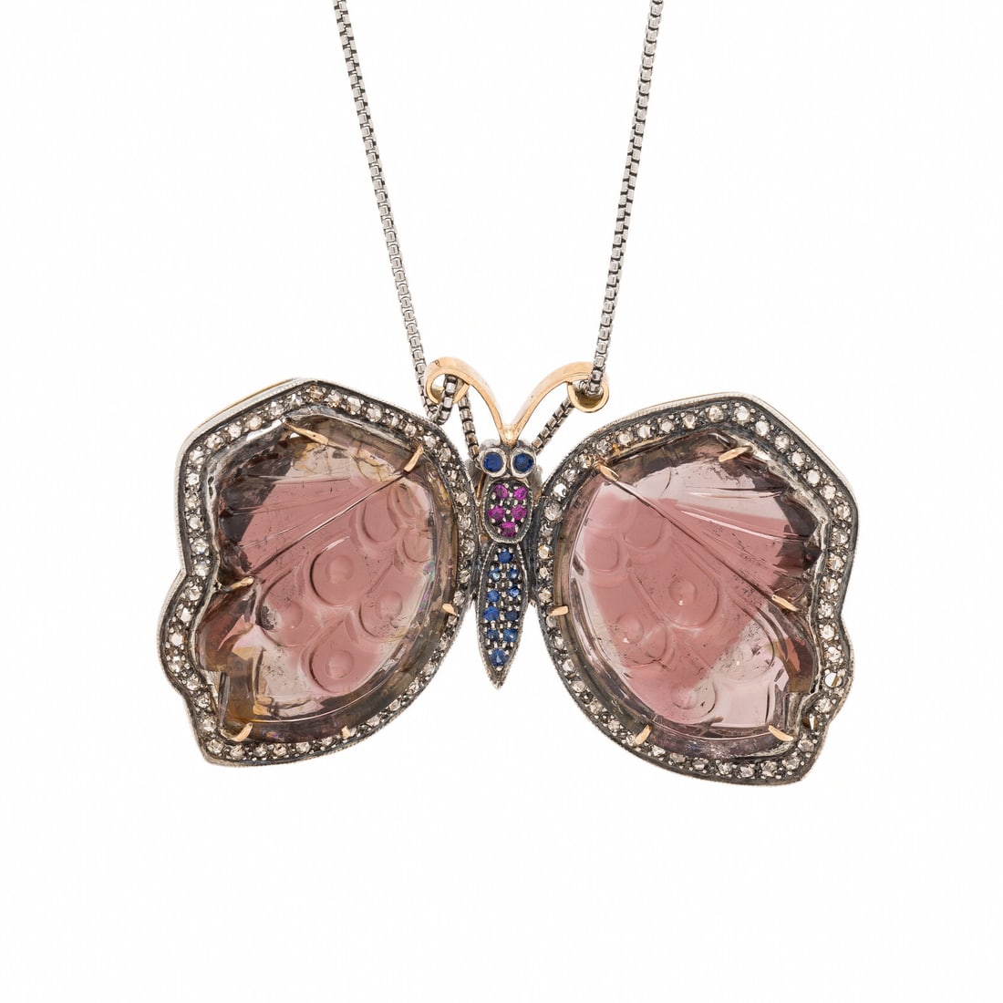 Carved Gem Butterfly Pendant Necklace: Carved Gem Butterfly Pendant Necklace Carved tourmaline, rose cut diamonds, and round rubies and sapphires. 14 karat yellow gold and silver. Chain: 16 1/2 inches long. Pendant: 2 1/4 x 1 1/4 inches.
