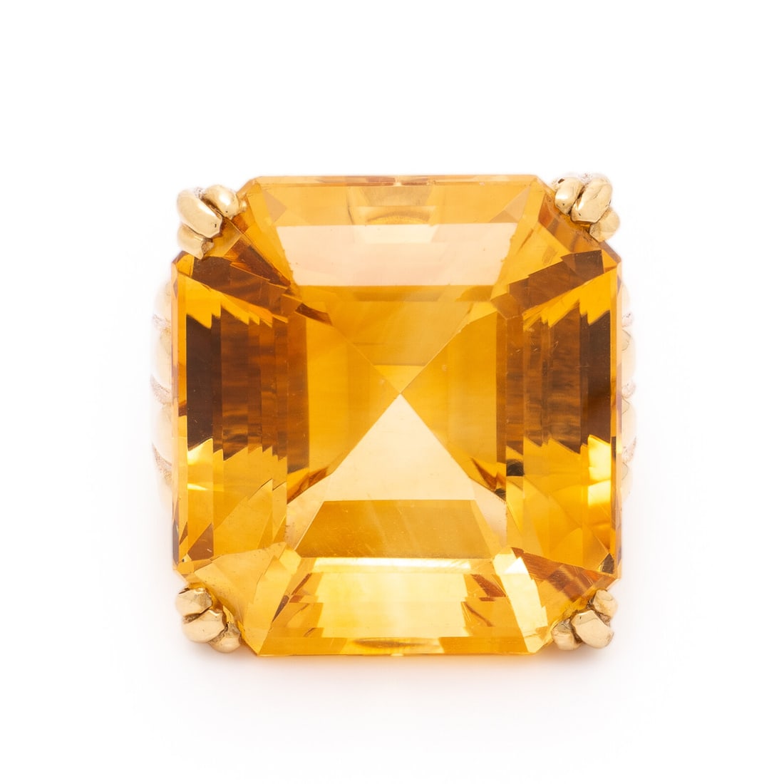 British, Citrine and Yellow Gold Ring: British, Citrine and Yellow Gold Ring Emerald cut citrine weighing approximately 40.00 carats by formula. 18 karat yellow gold. Ring size 6 1/2. Stamp: NCK 750 (British hallmarks). Gross weight: 17.55
