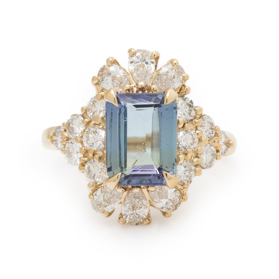 Tanzanite, Diamond, and Yellow Gold Ring: Tanzanite, Diamond, and Yellow Gold Ring Emerald cut tanzanite weighing approximately 3.08 carats, and round brilliant cut and pear shape diamonds weighing approximately 1.00 carat total. 14 karat