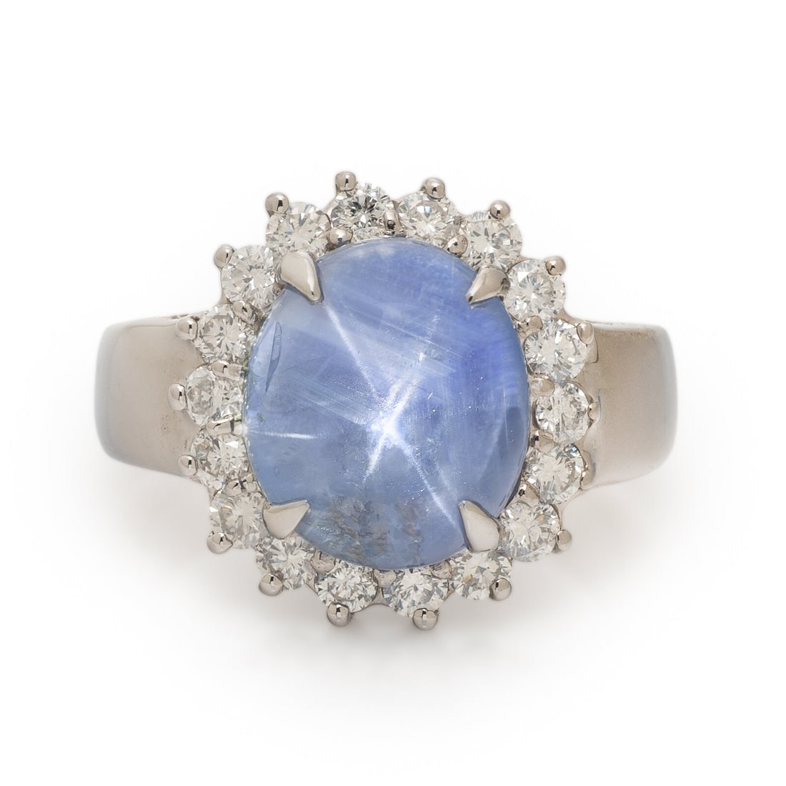 Star Sapphire, Diamond, and White Gold Ring: Star Sapphire, Diamond, and White Gold Ring Oval cabochon star sapphire measuring approximately 6.90 carats by formula, and round brilliant cut diamonds weighing approximately 0.70 carat total. 14