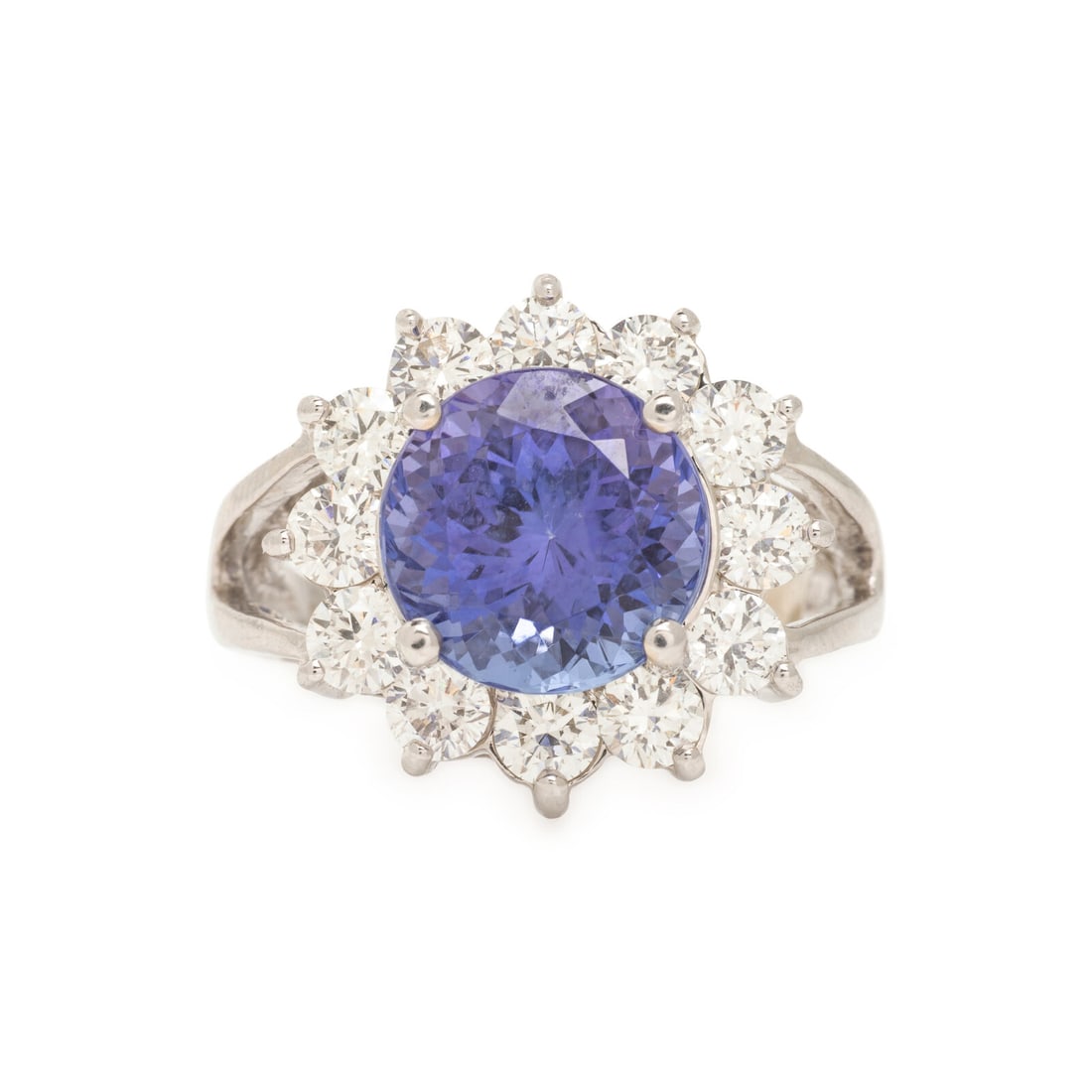 Tanzanite, Diamond, and White Gold Ring: Tanzanite, Diamond, and White Gold Ring Round tanzanite weighing approximately 4.25 carats by formula, and round brilliant cut diamonds weighing approximately 1.20 carats total. 14 karat white gold.