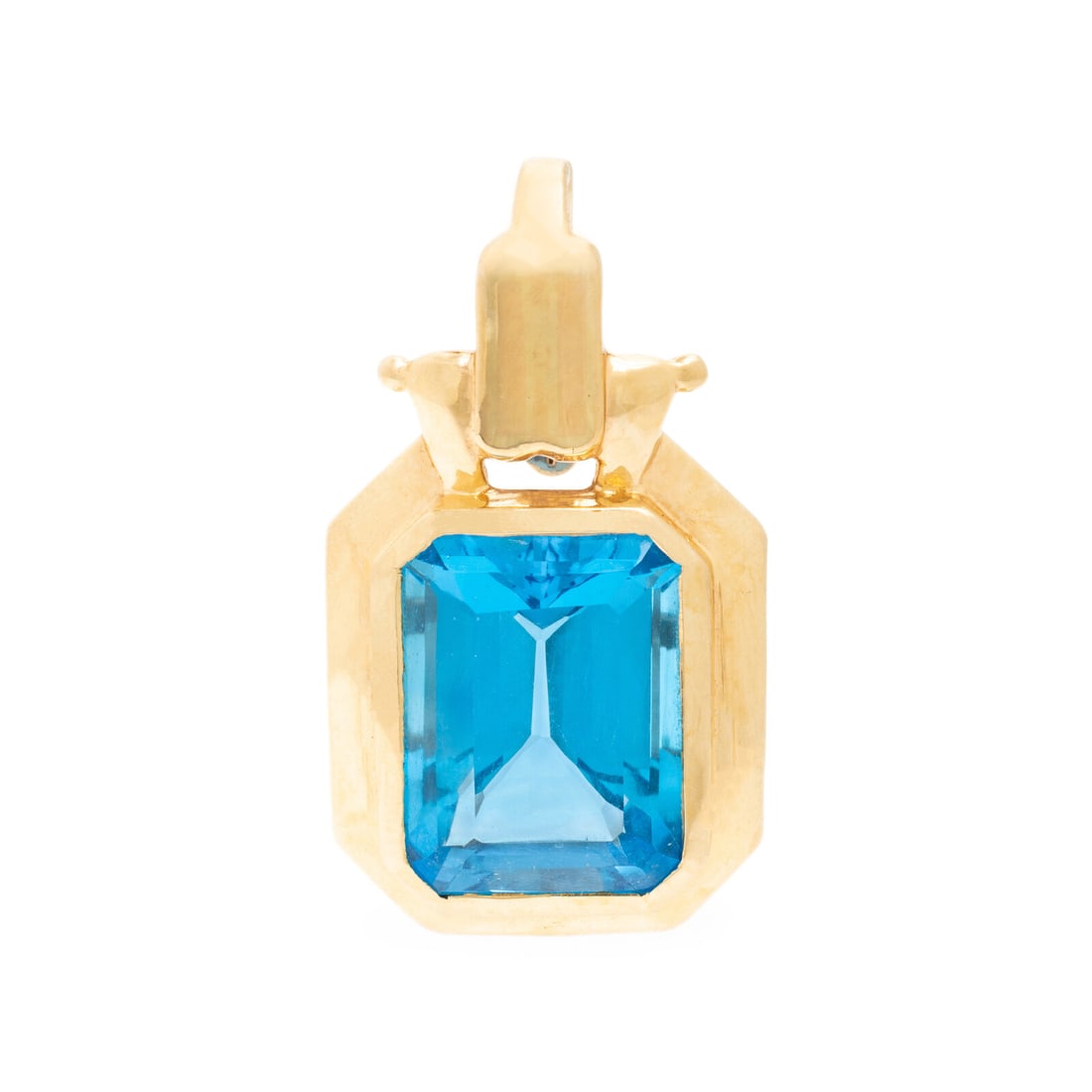 Blue Topaz and Yellow Gold Pendant: Blue Topaz and Yellow Gold Pendant Emerald cut blue topaz weighing approximately 13.85 carats by formula. 14 karat yellow gold. 1 1/4 x 3/4 inch. Stamp: 14K (maker's mark). Gross weight: 6.00 dwt.