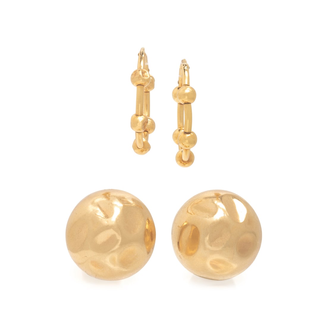 Two Pairs of Yellow Gold Earrings: Two Pairs of Yellow Gold Earrings Including a pair of dome earrings and a pair of hoop earrings. 14 and 18 karat yellow gold. 7/8 inch long, and 1 inch long, Stamp: (maker's mark) 14K. Stamp: 750