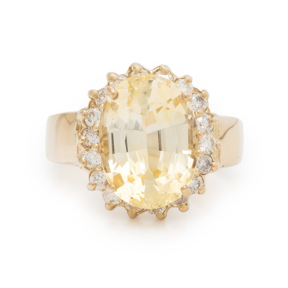 Ceylon, Yellow Sapphire, Diamond, and Yellow Gold Ring: Ceylon, Yellow Sapphire, Diamond, and Yellow Gold Ring Oval yellow sapphire weighing approximately 7.18 carats and round brilliant cut diamonds. 14 karat yellow gold. Ring size 6. Stamp: 14K. Gross we