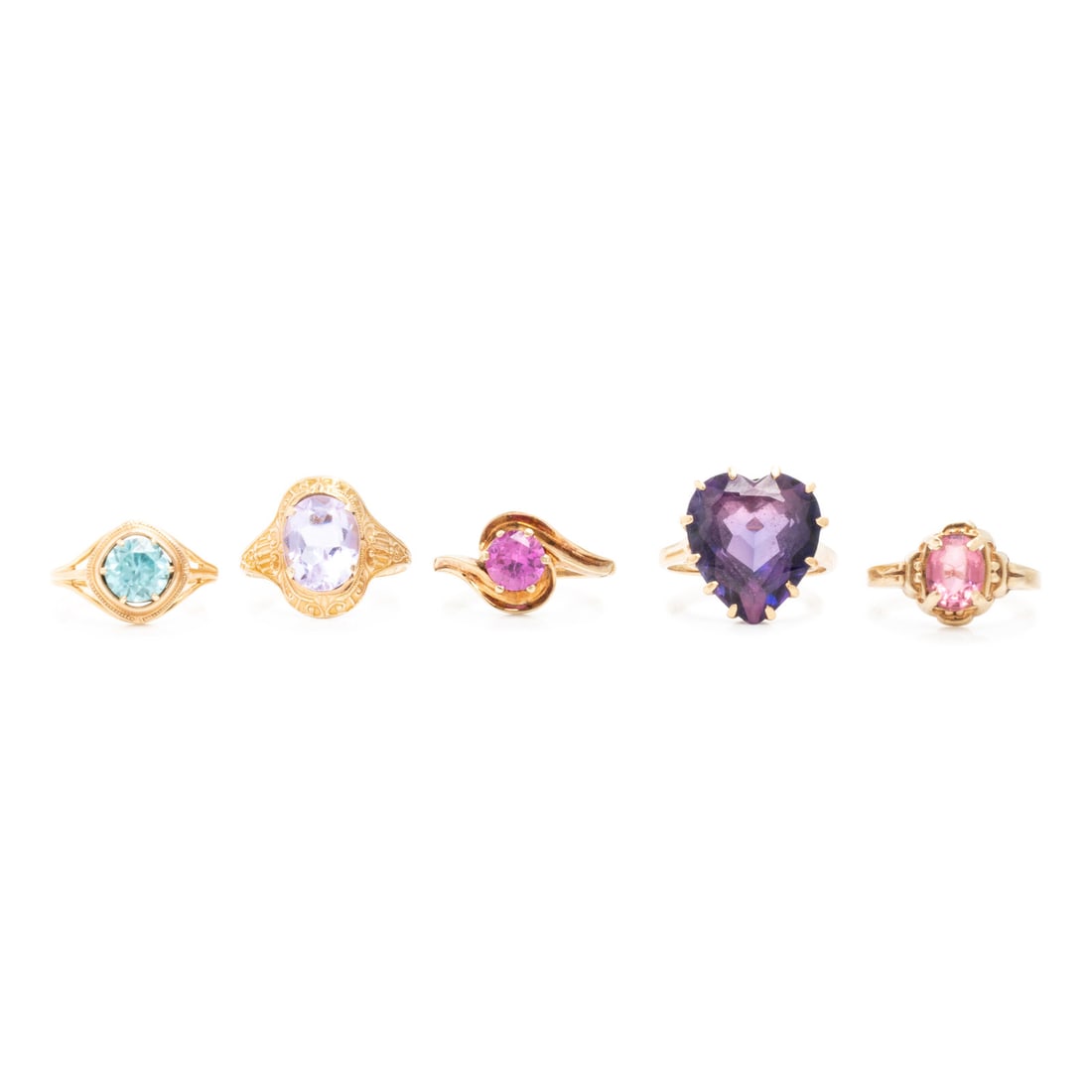 Collection of Low-Karat Gold Rings: Collection of Low-Karat Gold Rings Including five rings, one set with an oval purple glass stone, one set with an oval pink glass stone, one set with a round synthetic pink sapphire, one set with roun