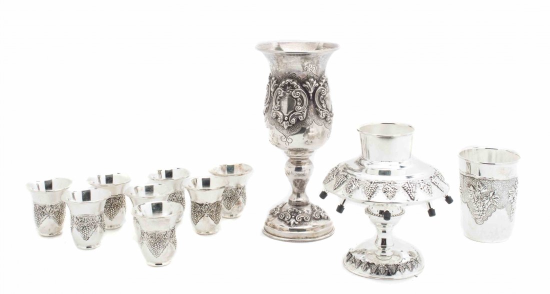 A Sterling Silver Israeli Chalice, Height of tallest 7: A Sterling Silver Israeli Chalice, together with a silver-plate wine dispenser, 8 small cups and a larger example. Height of tallest 7 1/2 inches.