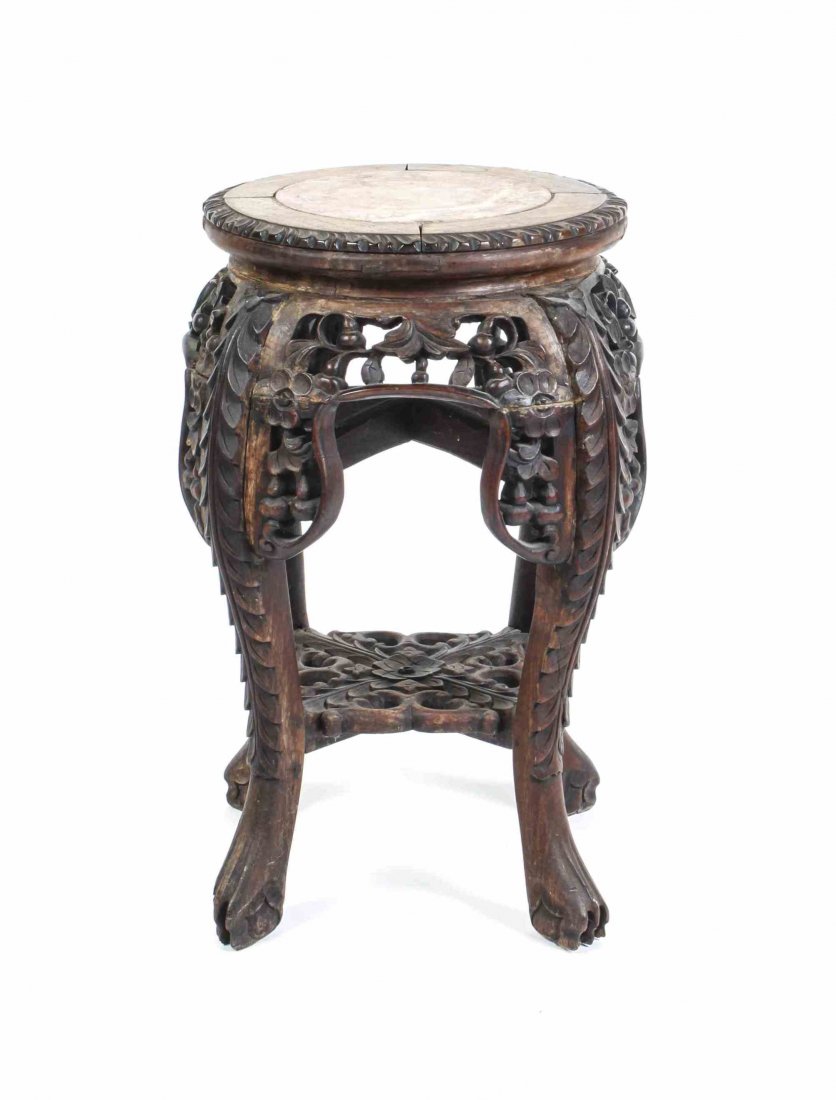 A Chinese Carved Hardwood Stool, Height 18 1/2 inches.: A Chinese Carved Hardwood Stool, having a circular marble inset top over a pierce carved frieze, raised on cabriole legs joined by stretchers, ending in ball and claw feet. Height 18 1/2 inches.