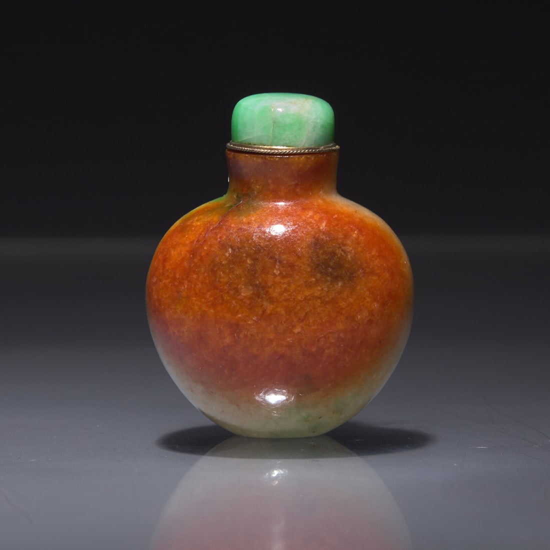 A Chinese Russet-Splashed Jadeite Snuff Bottle, 19th/20th Century: A Chinese Russet-Splashed Jadeite Snuff Bottle, 19th/20th Century 清晚期 帶皮翡翠鼻煙壺 19th/20th Century Of tapered, slightly flattened bul